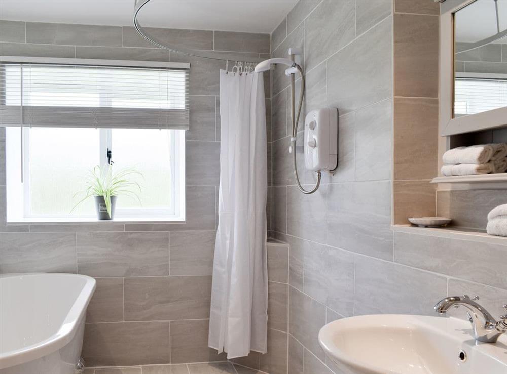 Family bathroom with bath and separate shower area at Cherry Cottage, 