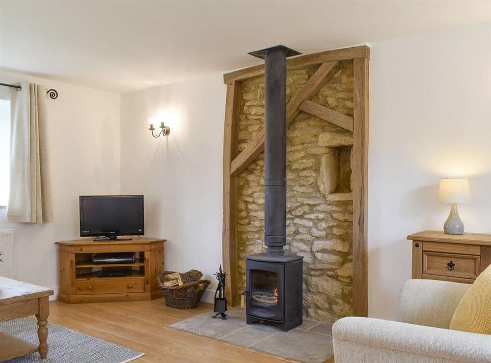 Welcoming living room with wood burner at Cherry Cottage, 