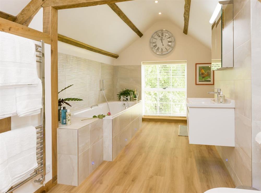 Luxurious bathroom with bath and walk-in shower at The Calf Shed, 