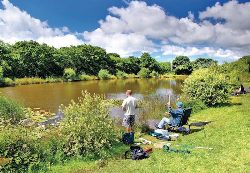 Fishing by the lake at Wooda Lakes in North Devon, South West of England