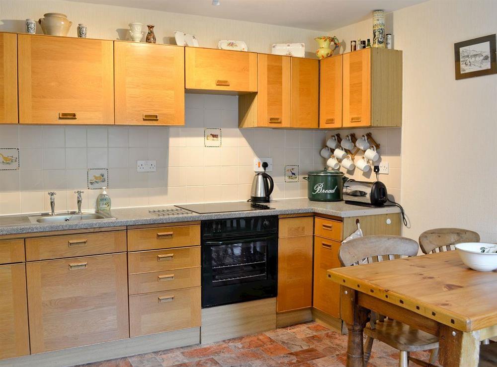 Kitchen with dining area at Woodbine Cottage in Fort Augustus, Loch Ness, Highland