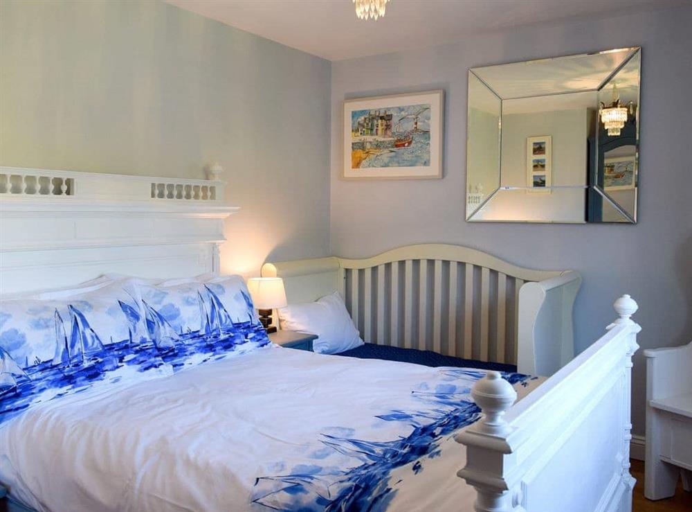 Comfomfortable double bedroom with additional single bed at Woodbrook Cottage in Bothenhampton, near Bridport, Dorset