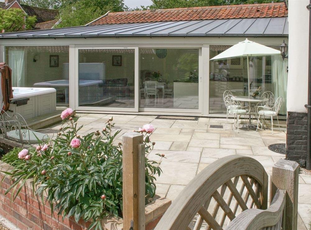 Lovely holiday home with enclosed paved patio area at Woodcrest Farm Barn in Roydon, near Diss, Norfolk