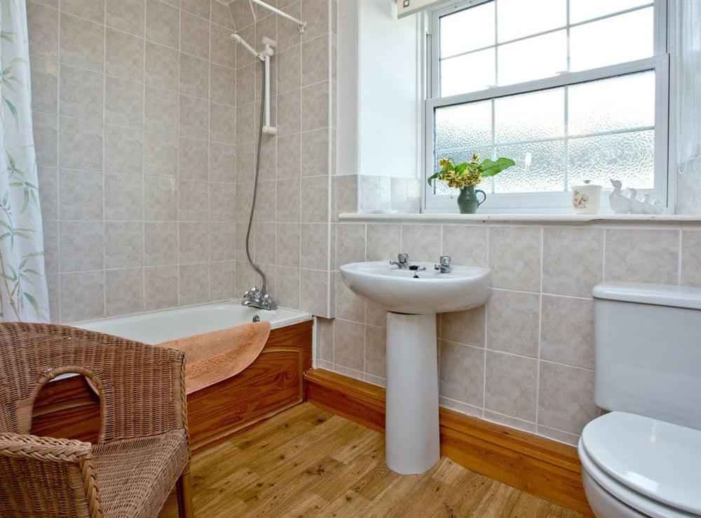 Family bathroom with shower over bath at Chinkwell, 