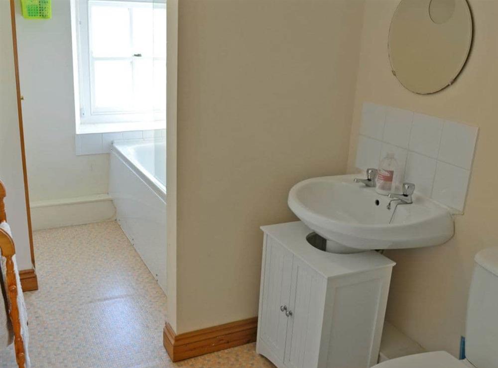 Bathroom with shower over bath at Woodford Cottage in Rosudgeon, near Penzance, Cornwall