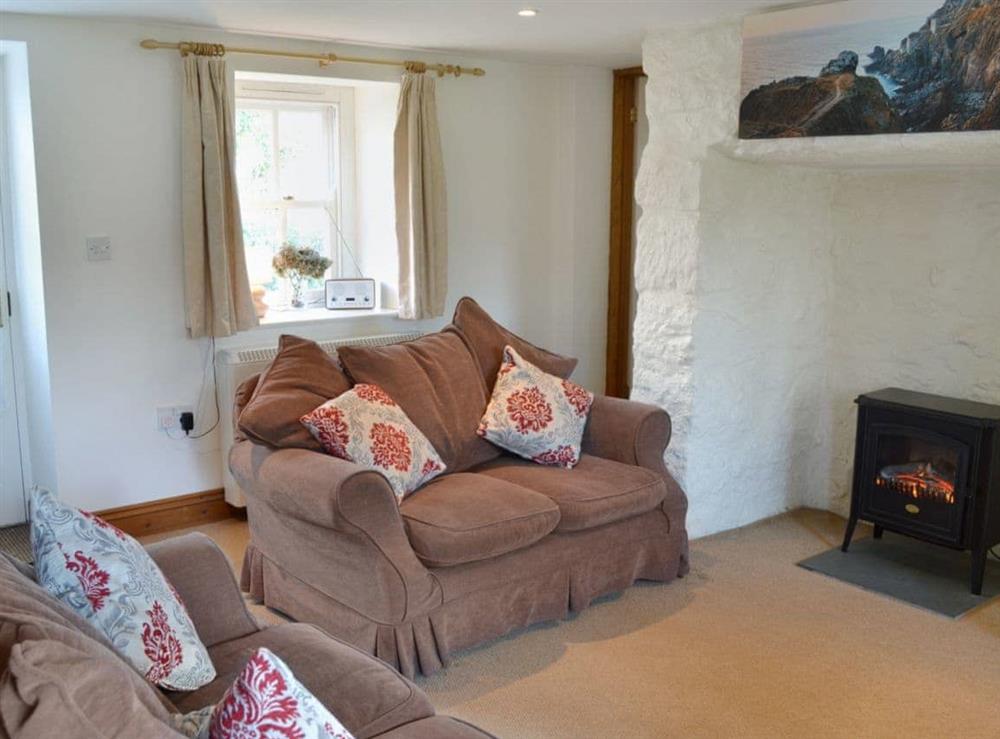Charming living/dining room with cosy wood burner (photo 3) at Woodford Cottage in Rosudgeon, near Penzance, Cornwall