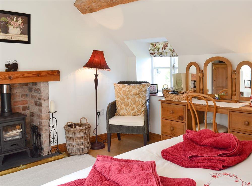 Double bedroom with multi-fuel burner at Woodhouse Cottage in Dobshill, Nr Chester, Flintshire., Clwyd