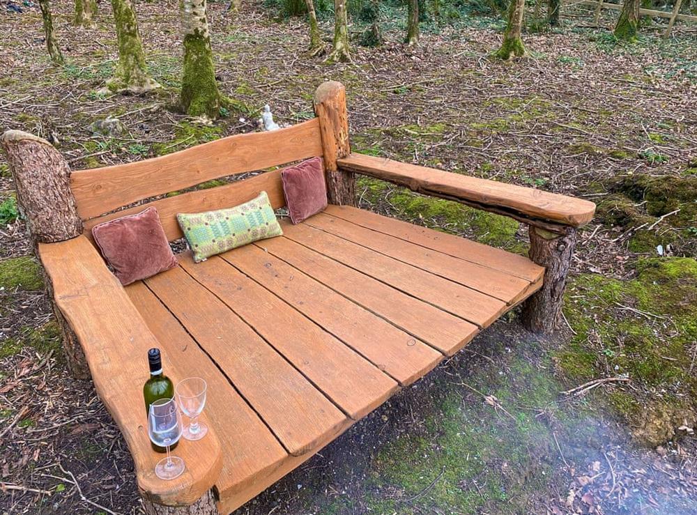 Giant size bench in the woods to chill out with the fire pit at Woodland Barn in Rhos, Pembrokeshire, Dyfed