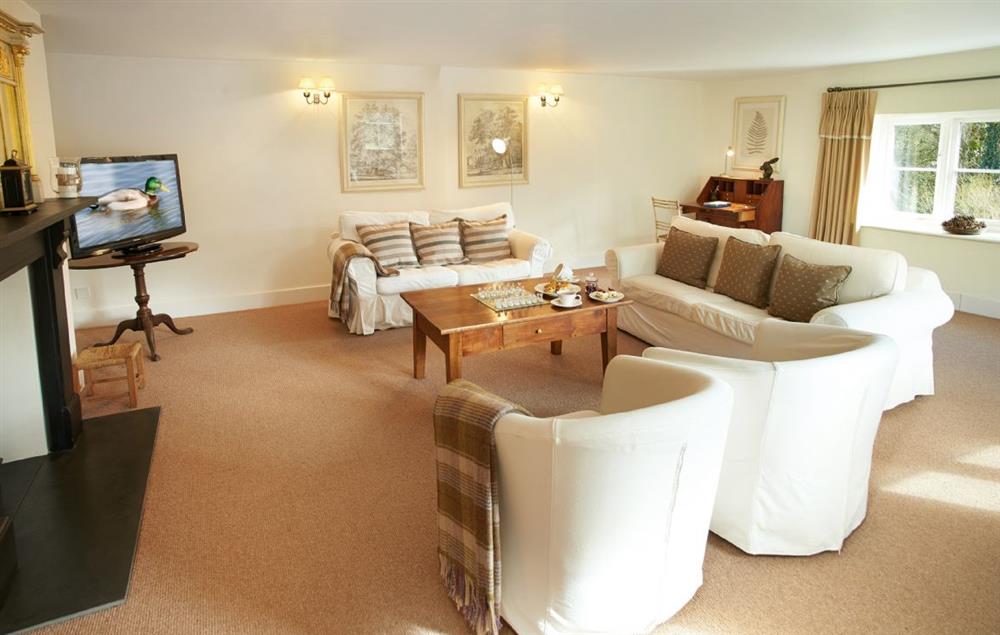 Comfortable sitting room with electric wood burner and comfortable sofas (photo 2) at Woodland Cottage (Devon), Romansleigh