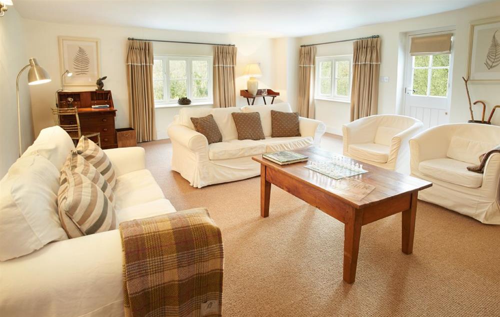 Comfortable sitting room with electric wood burner and comfortable sofas at Woodland Cottage (Devon), Romansleigh