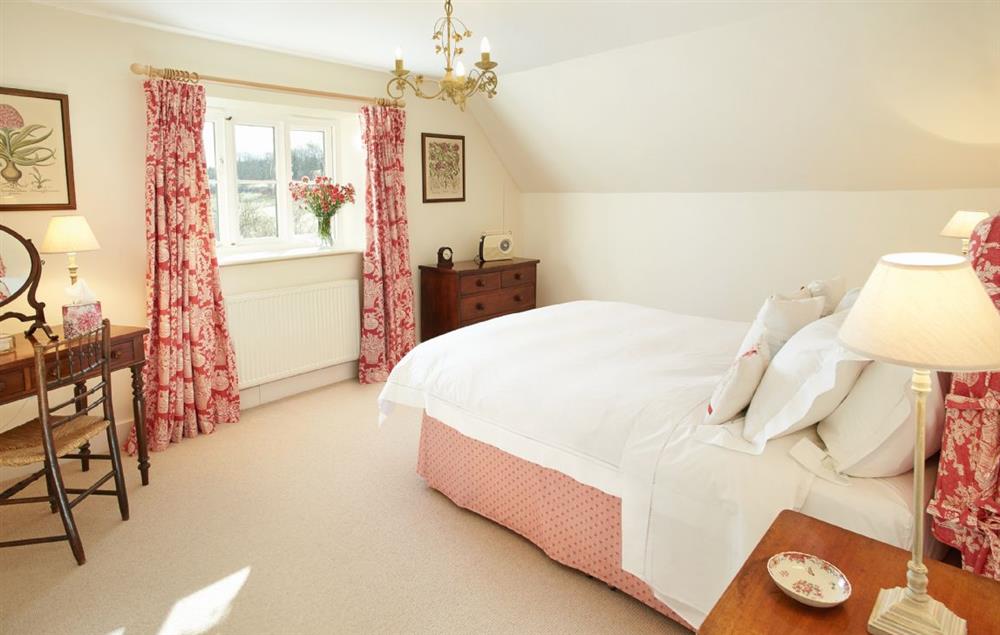 Master bedroom with king size 5’ bed and dressing table at Woodland Cottage (Devon), Romansleigh