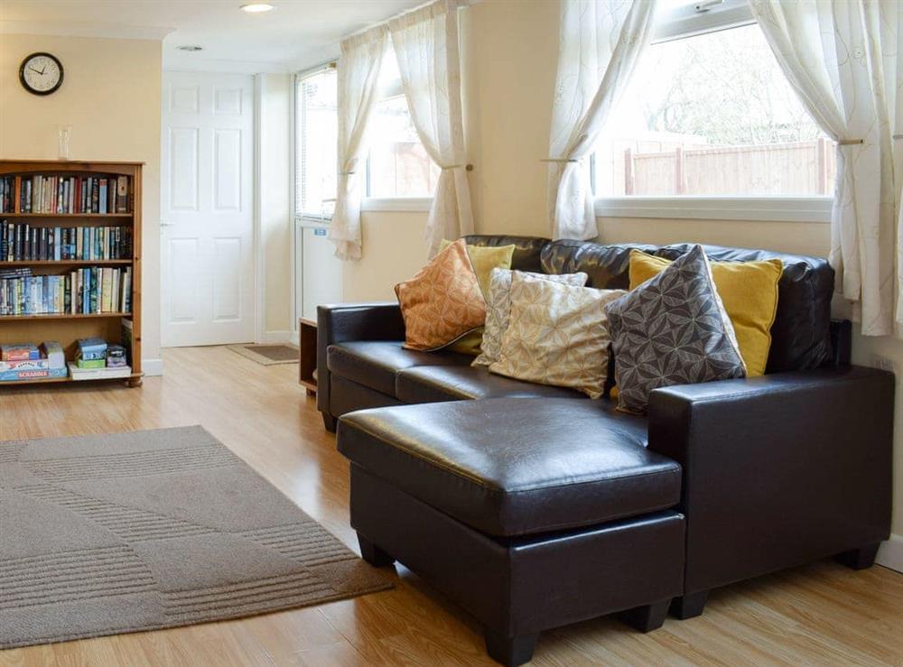 Comfy seating within living area at Woodland Lodge in Rustington, near Littlehampton, West Sussex