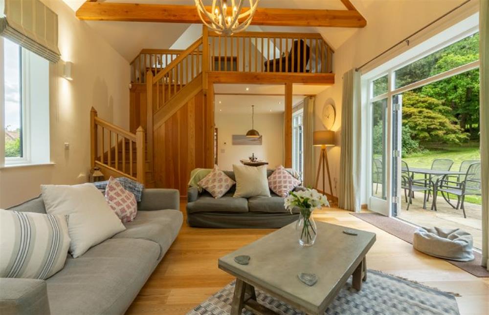 Ground floor: Open-plan sitting area with oak staircase at Woodland Pytchley, West Runton near Cromer