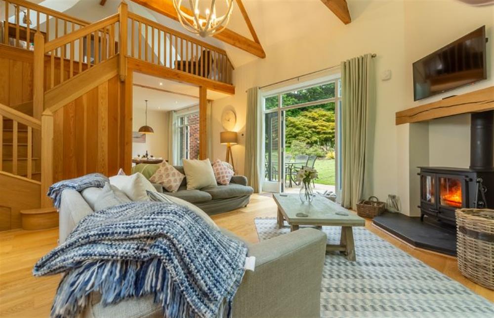 Ground floor: Sitting area with feature wood burning stove at Woodland Pytchley, West Runton near Cromer