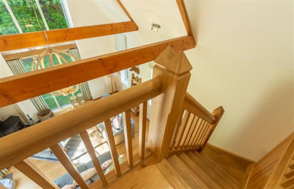 Oak staircase leads to the mezzanine above at Woodland Pytchley, West Runton near Cromer