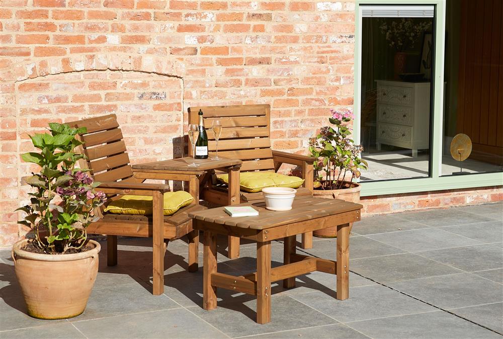 Outdoor seating on the terrace at Woodland Retreat, Burton on Trent