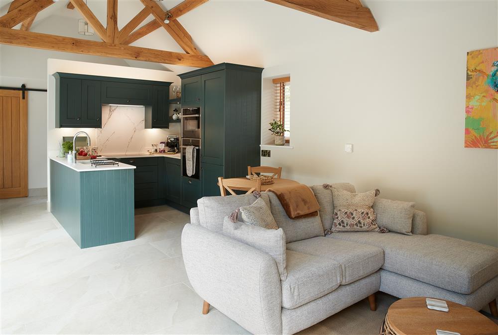 The open-plan living space with exposed beams at Woodland Retreat, Burton on Trent