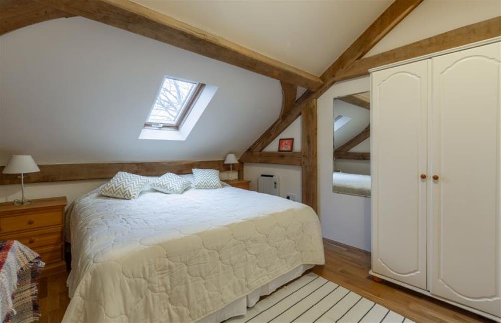King-size bed with wardrobe and chest of drawers at Woodland Retreat Lodge, Brundish