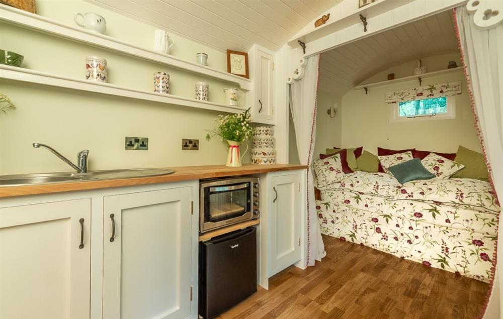 Self contained with a day bed that converts to a comfortable double bed at night at Woodland Retreat Shepherds Hut, Brundish