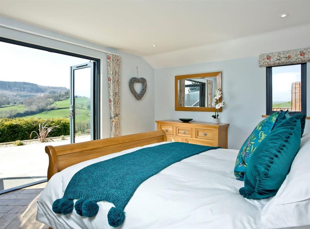 Relaxing double bedroom with beautiful views at Woodland View Lodge in Axminster, Devon