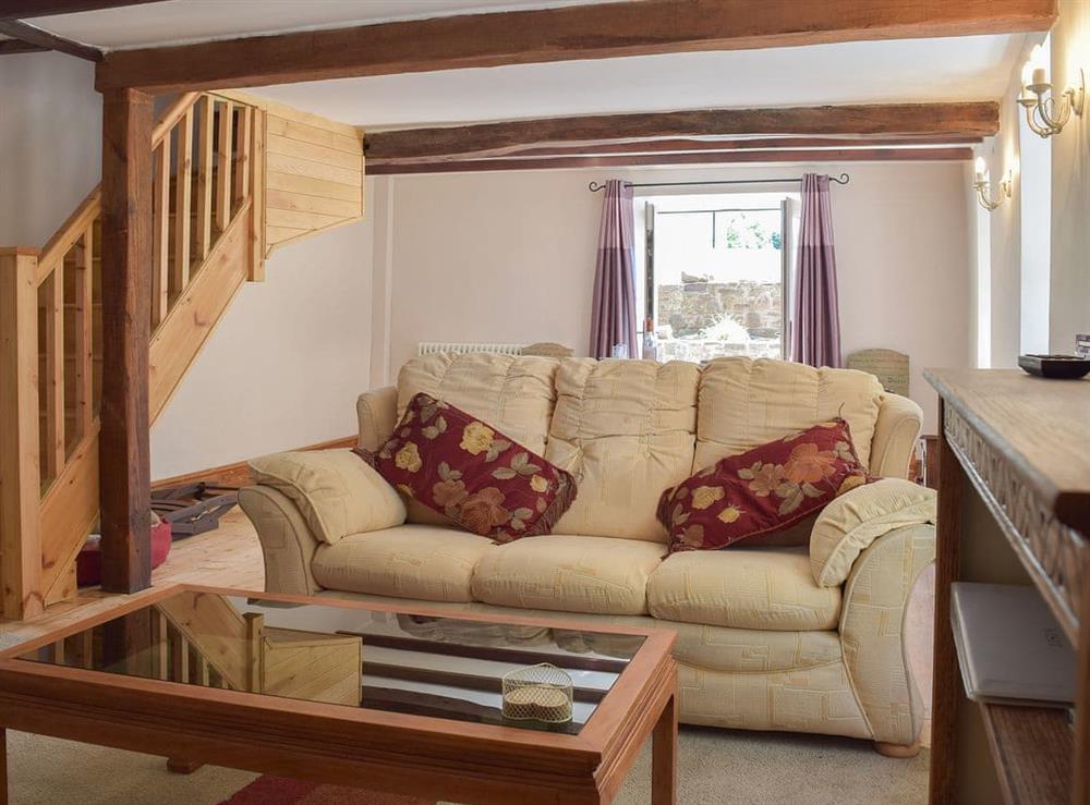 Beamed living room with comfortable furniture at Woodlands in Laugharne, near Pendine, Carmarthenshire, Dyfed