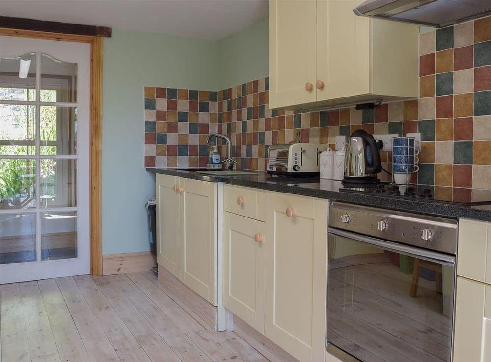 Well-appointed kitchen with granite tiled worktops at Woodlands in Laugharne, near Pendine, Carmarthenshire, Dyfed