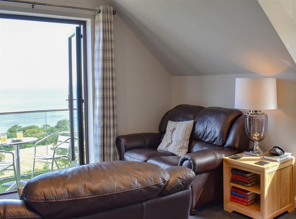Living area leading onto balcony at Woodlea Cottage 1 in Dippen, near Whiting Bay, Isle of Arran, Scotland