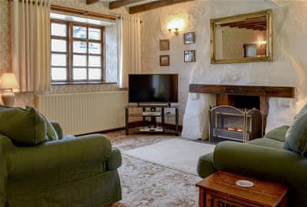 Characterful living room with original beamed ceiling at Woodlea Cottage 2 in Whiting Bay, near Dippen, Isle Of Arran