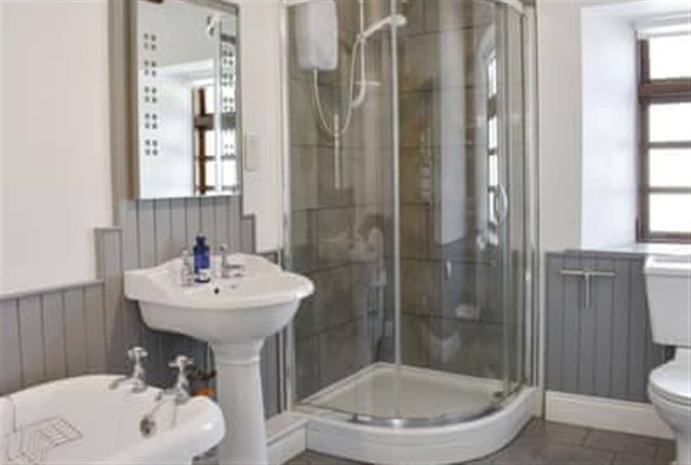 Well presented bathroom with separate free-standing, roll-top bath and shower cubicle at Woodlea Cottage 2 in Whiting Bay, near Dippen, Isle Of Arran