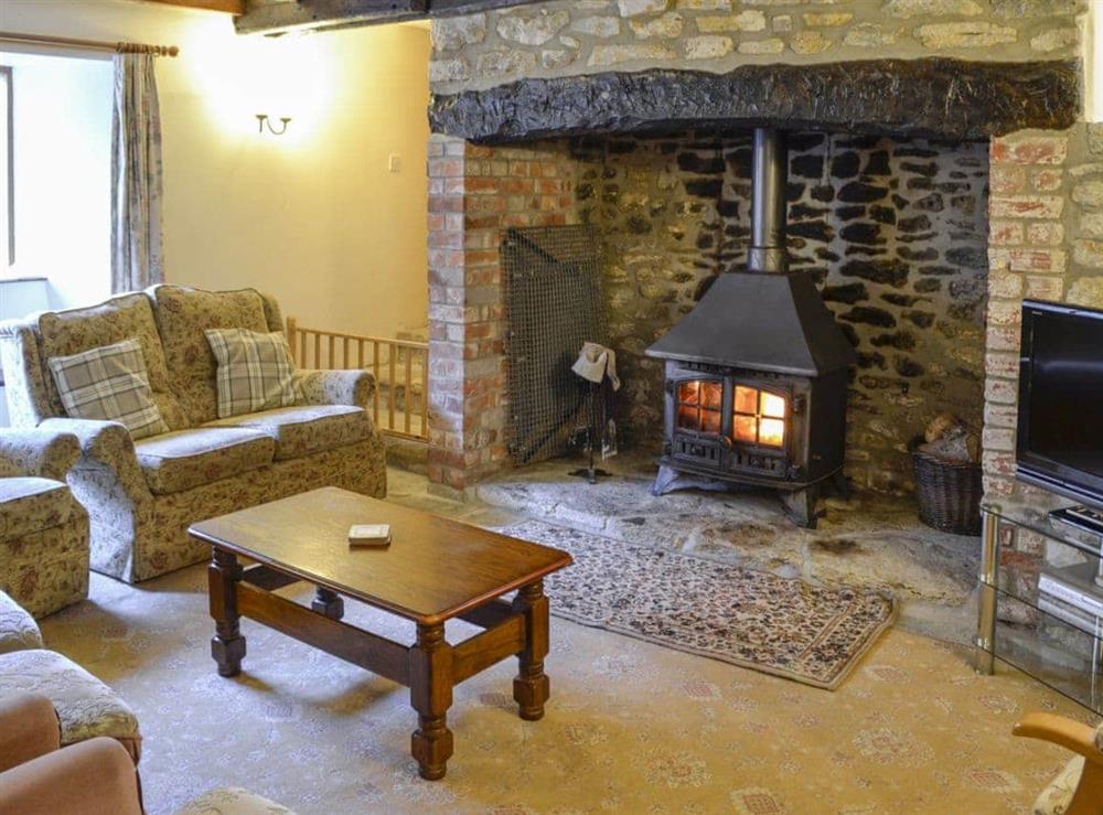 Cosy and welcoming living room with woodburner at Woodmans Cottage in Puncknowle, Dorchester., Dorset