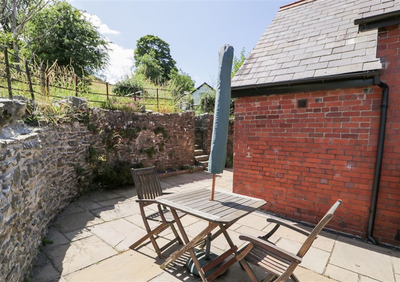 Enjoy a glass of wine on the patio at Woodpecker Cottage, Llangollen