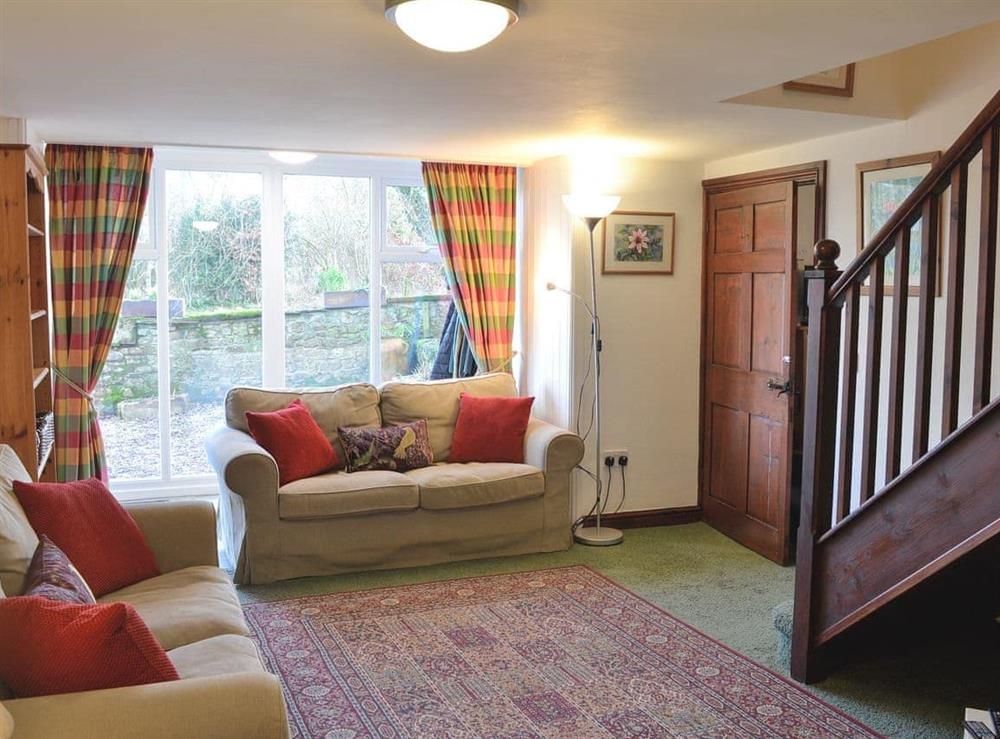 Living room with large picture window at Woodpecker Cottage in Wigton, Cumbria