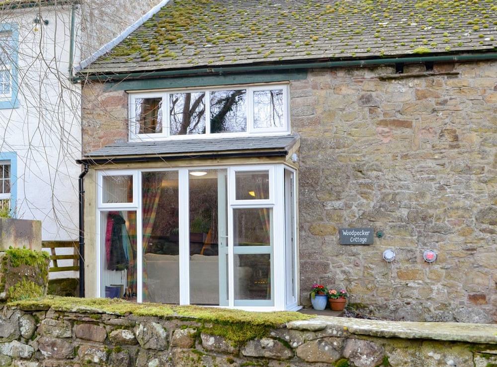 Stone-built traditional lakeland farmhouse property at Woodpecker Cottage in Wigton, Cumbria