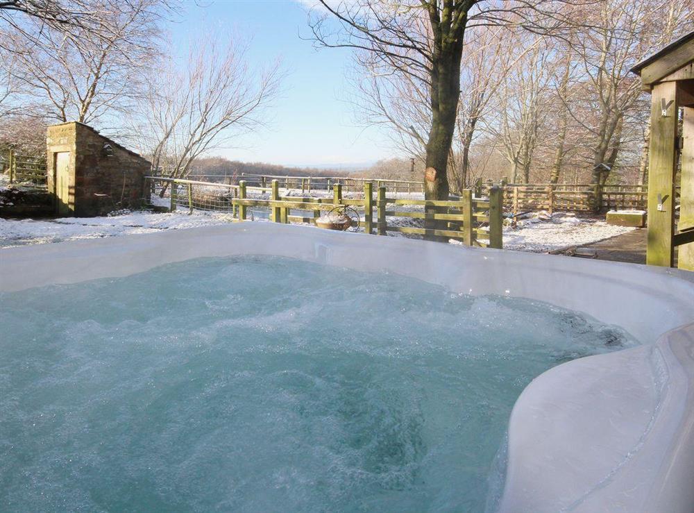 Views across the rolling lakeland countryside can be enjjoyed from the hot tub at Woodpecker Cottage in Wigton, Cumbria