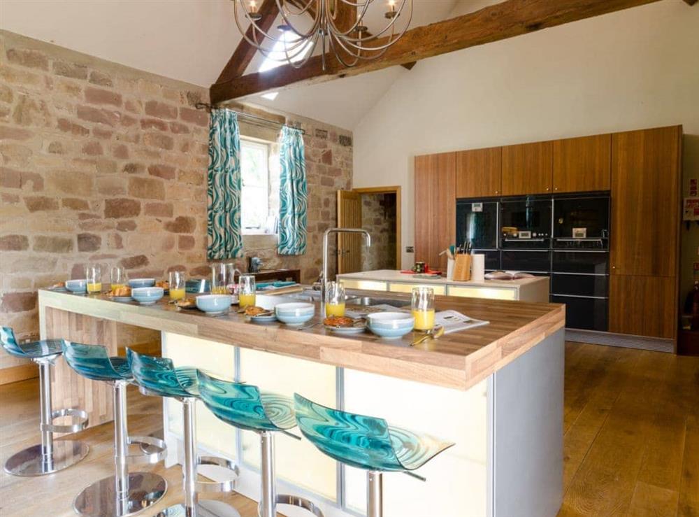 Open plan living space with breakfast bar at Woodpecker Lodge in near Carsington, Derbyshire