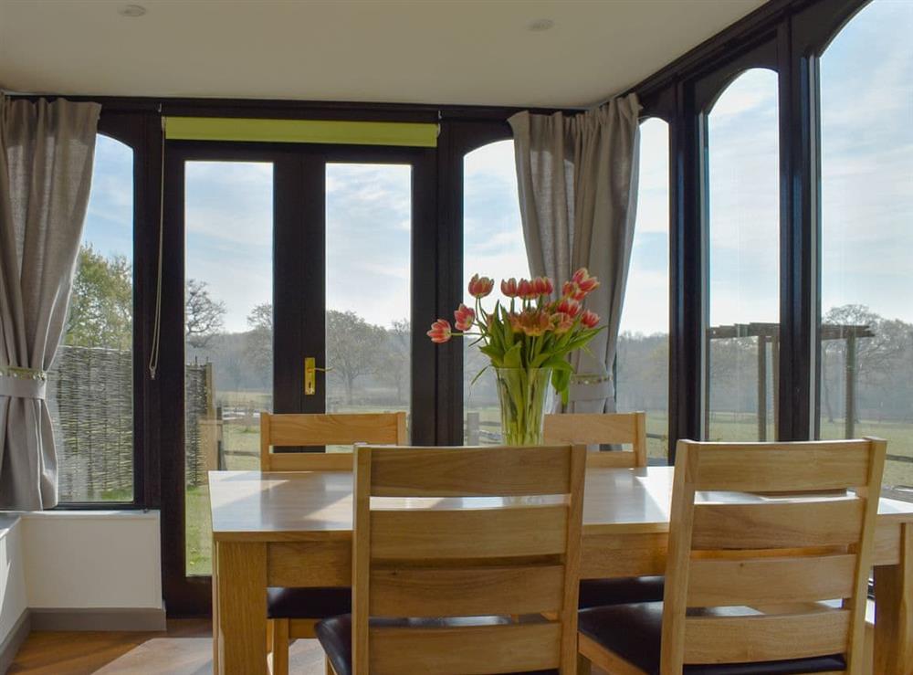 Conservatory with dining area at Woodpeckers in Cowbeech, near Hailsham, East Sussex