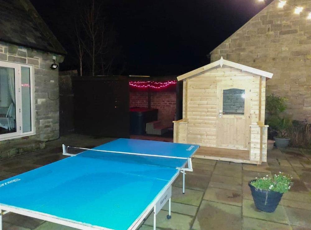 Nighttime view of the table tennis, hot tub and sauna at Woodside Cottage in Near Easington, Cleveland