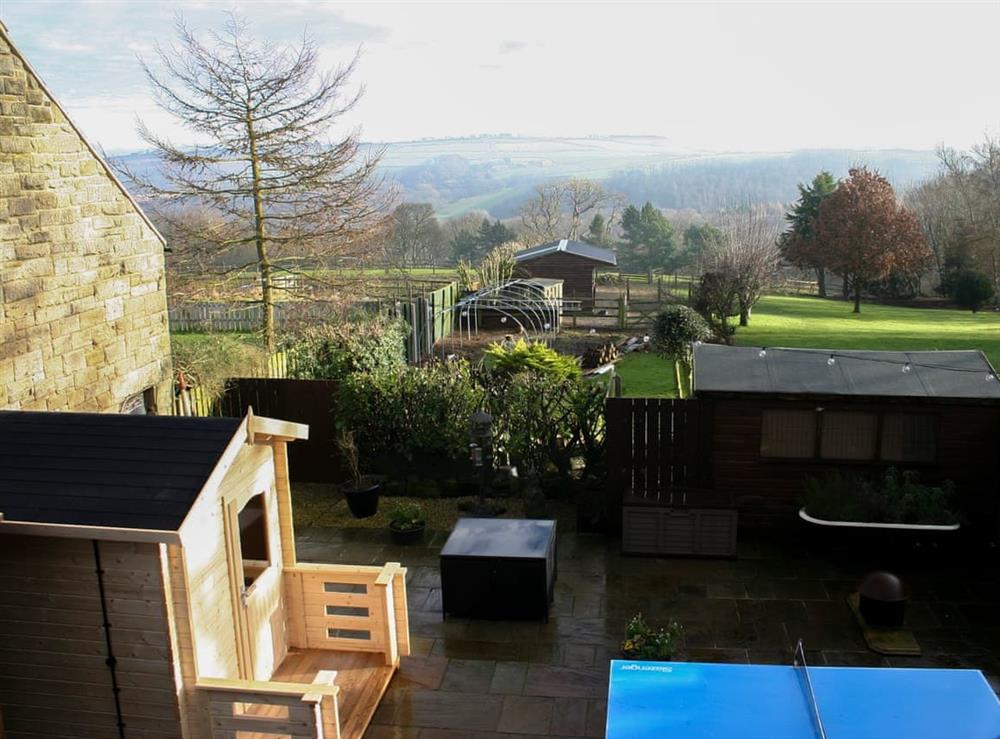 Patio area with Sauna, table with seating and table tennis plus a lovely view across the valley to the moors beyond at Woodside Cottage in Near Easington, Cleveland