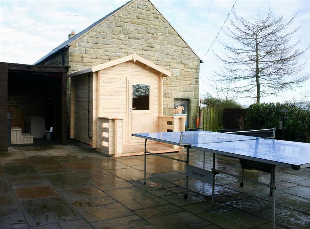 Paved patio, hot tub and adjacent sauna at Woodside Cottage in Near Easington, Cleveland