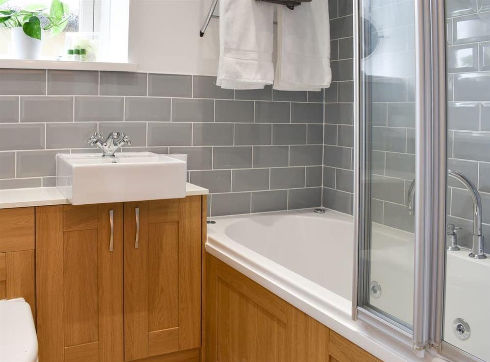 Stylish bathroom with shower over the bath at Woodside Cottage in Near Easington, Cleveland
