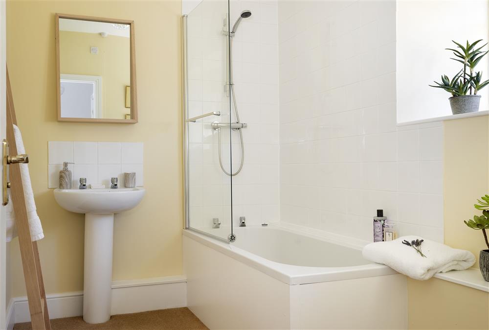 Bathroom with bath and overhead shower at Wormsley Grange and Cottage, Hereford