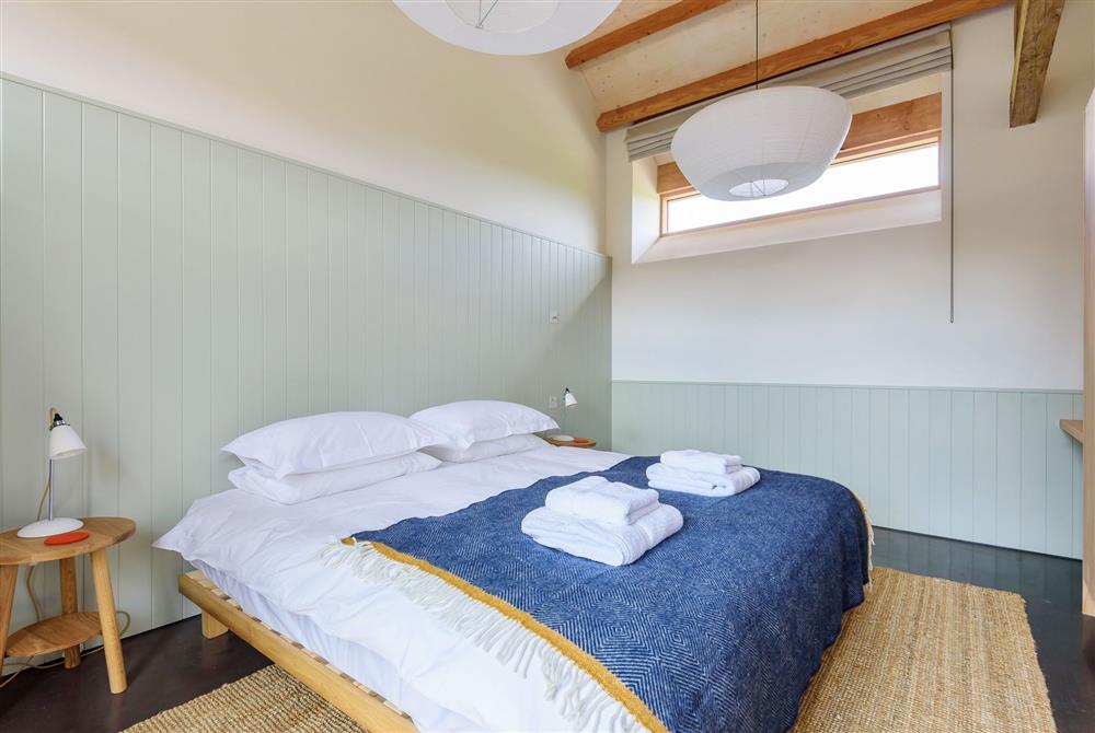 Clementine for four guests, bedroom one with a 6’ super king-size bed and an en-suite bathroom at Wraxall Yard, Dorchester