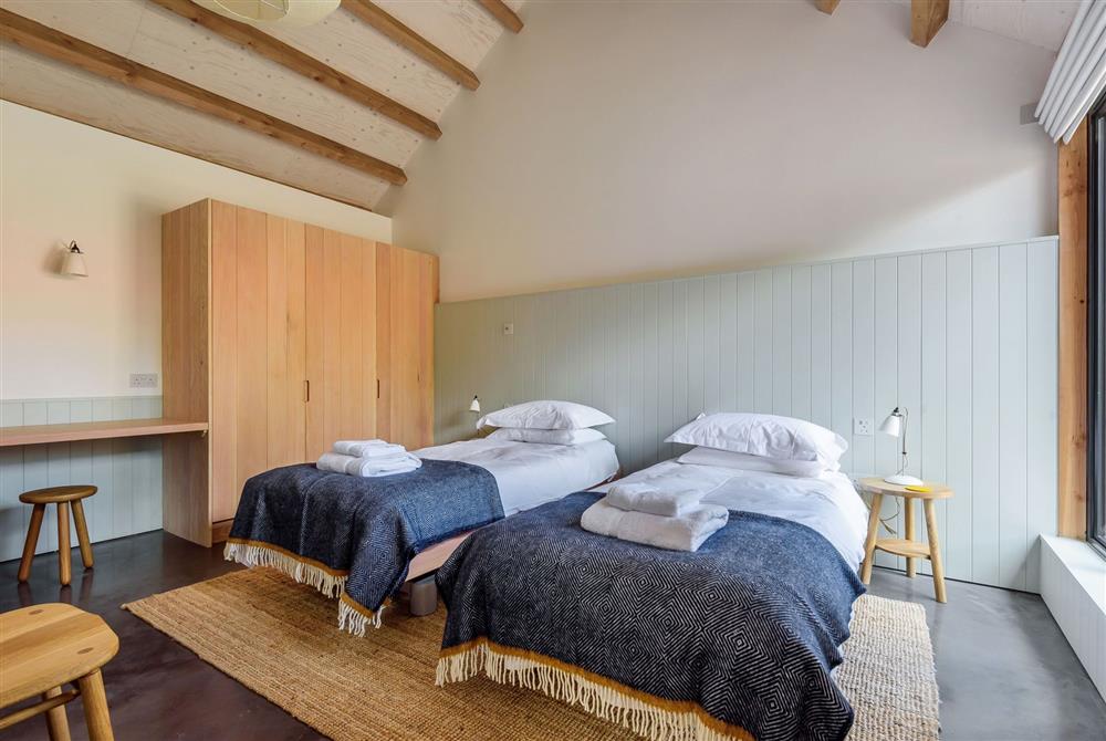 Kittwhistle for four guests, bedroom two with twin profiling beds and exposed beams at Wraxall Yard, Dorchester