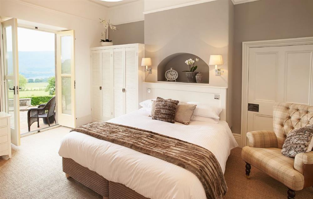 Master bedroom with 6’ bed and en-suite bathroom with bath, separate power shower and wc at Wreay Mansions, Watermillock