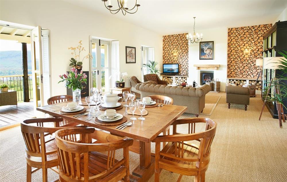 Open plan living and dining room with three double doors opening onto a balcony (photo 2) at Wreay Mansions, Watermillock