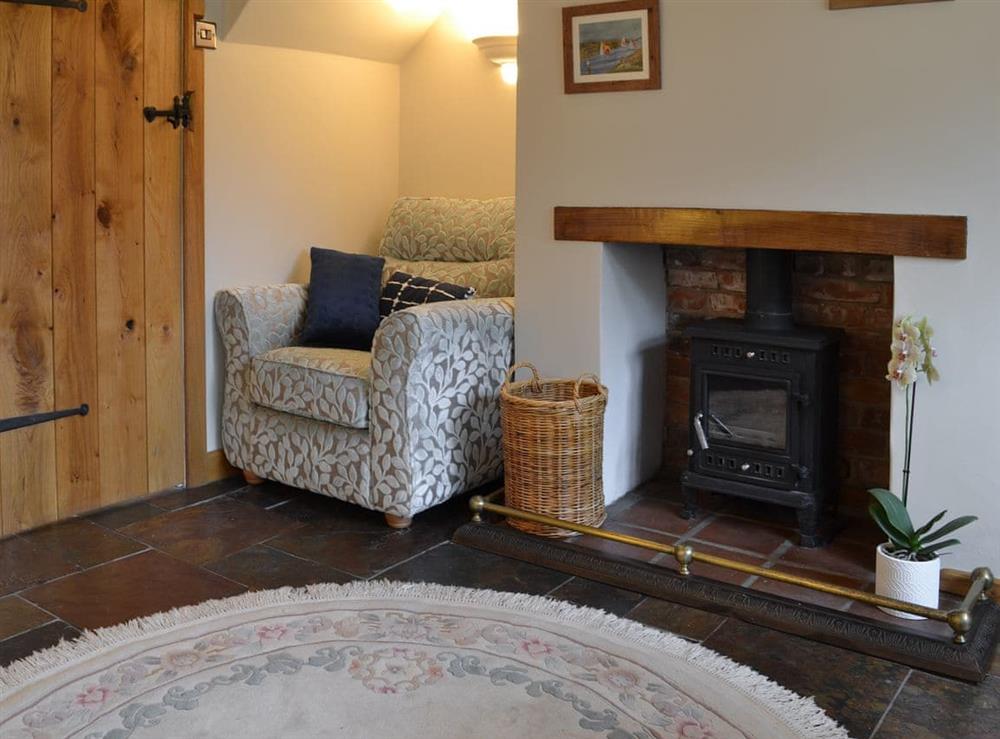 Living room with wood burner at Wren Cottage in Hindringham, near Fakenham, Norfolk