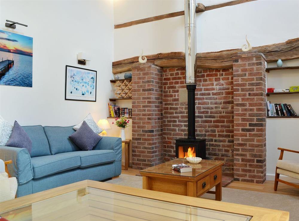 Luxurious living room with wood-burning stove at The Malthouse, 