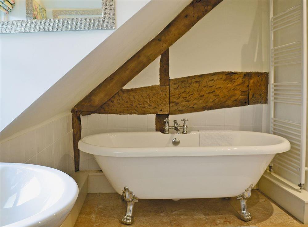 Bathroom with roll-top bath at Wrockwardine Cottage, 
