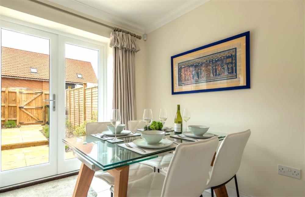 Ground floor: Dining area with french doors to the garden at Wye Cottage, Holt