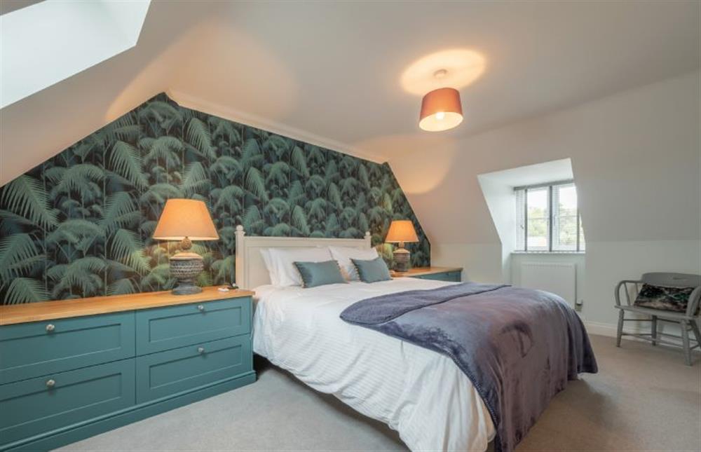 Second floor: Master bedroom with king-size bed at Wye Cottage, Holt